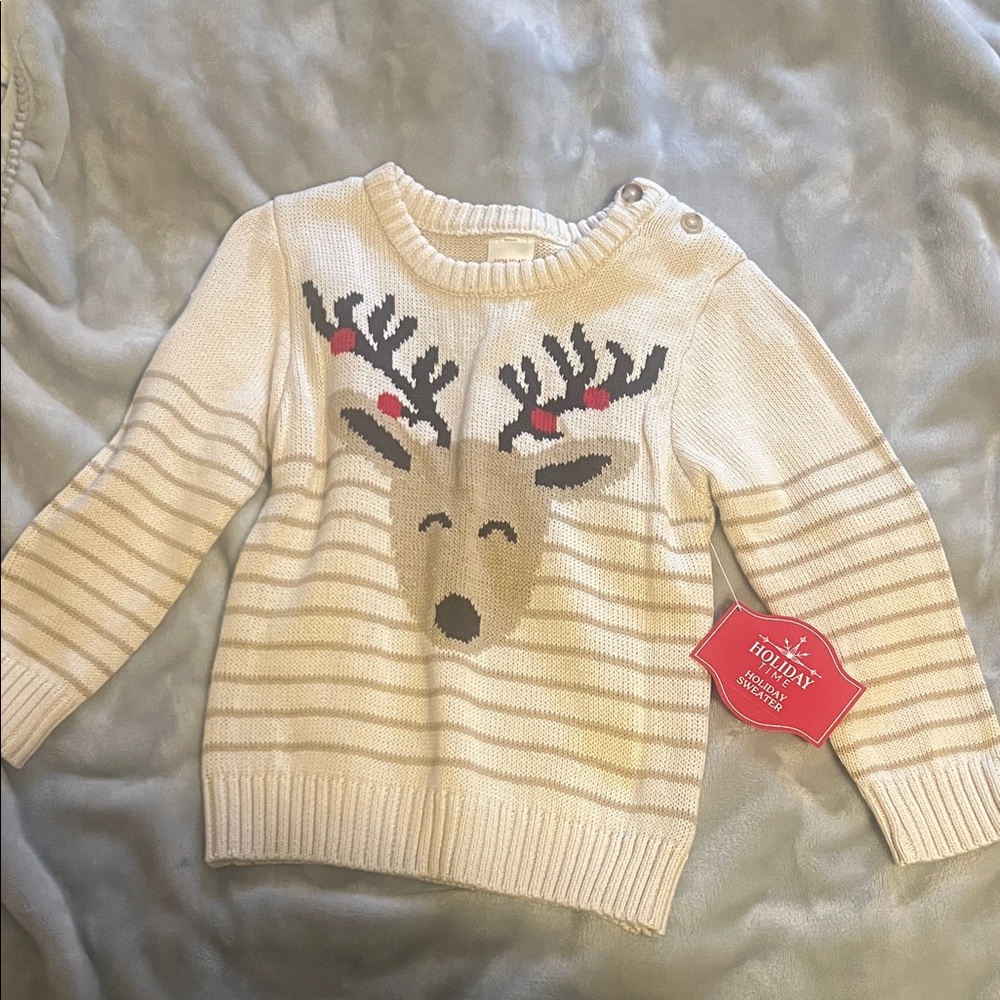 Cute reindeer sweater with button shoulders.